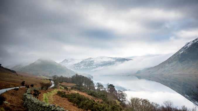Winter view towards Buttermere from Crummock Water with snow capped fells and low cloud